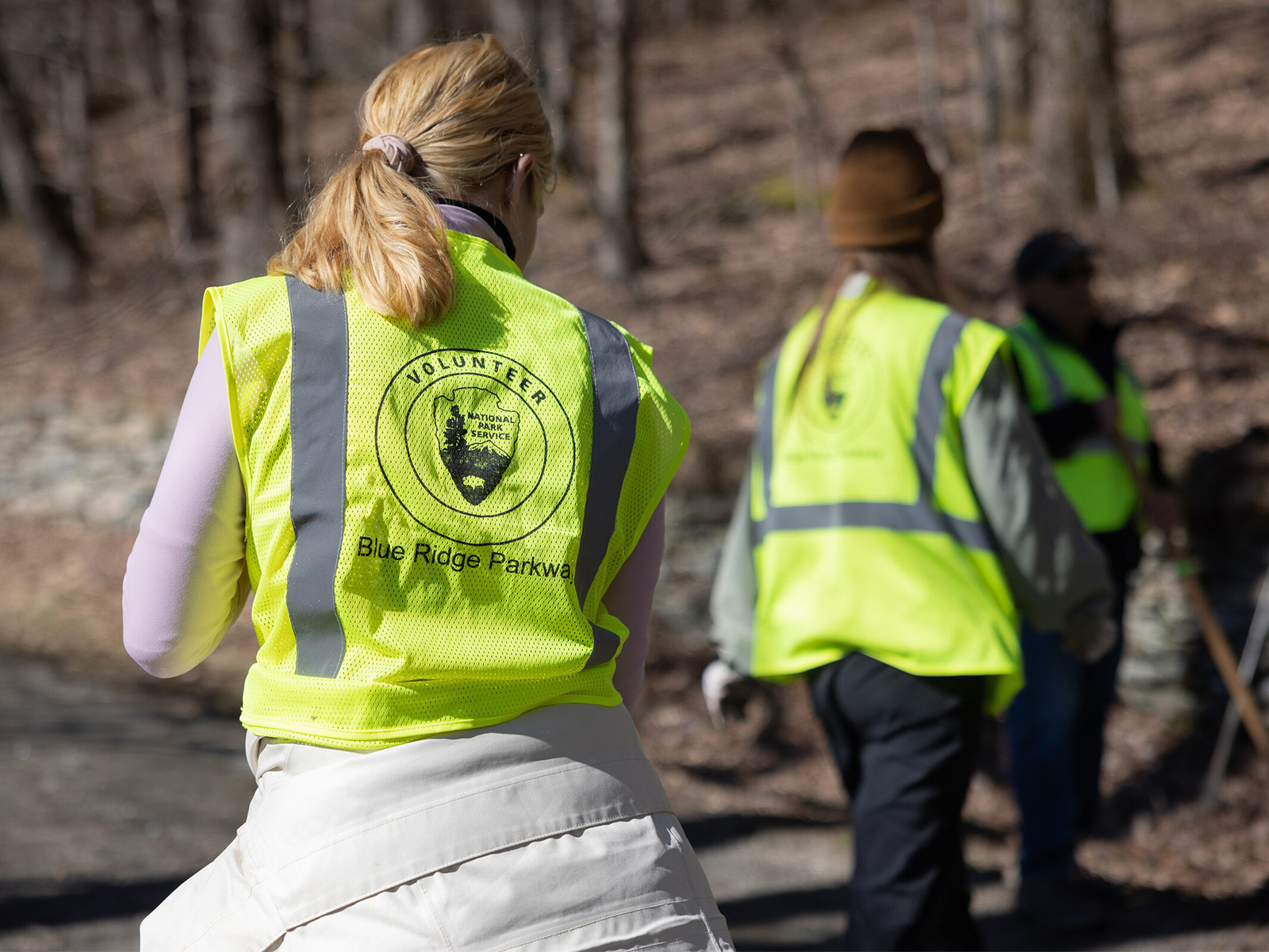 A volunteer wearing a high visibility vest as they 